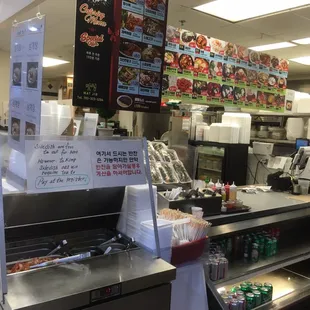 The kimchi stand next to the overhead meni