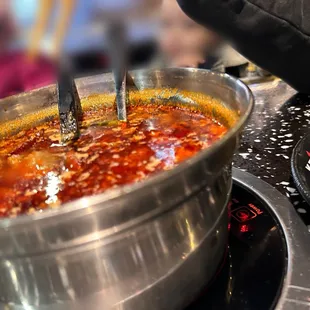 a closeup of a hot pot of soup being cooked