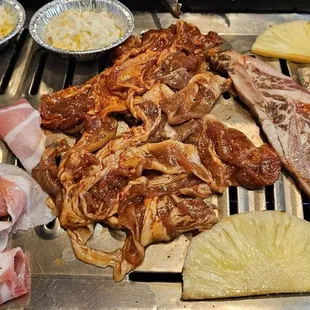a variety of meats on a grill
