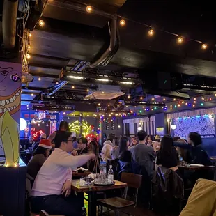 people sitting at tables in a restaurant