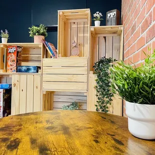 a wooden table with a potted plant on it