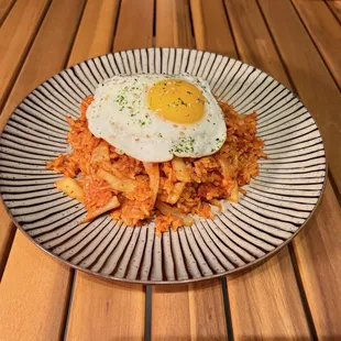 a plate of food with a fried egg on top