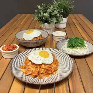 two plates of food on a wooden table