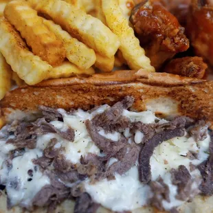 a steak sandwich with fries