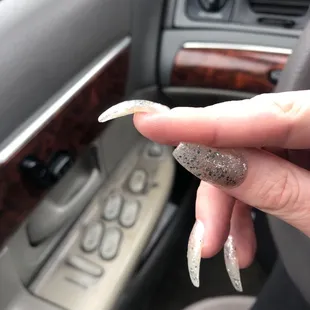 What the hell THIS!? He glued on a nail that FELL OFF! AND for a fill it cost the same to get a full set! Never again.