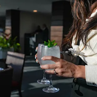 a woman holding a glass of water