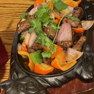 Bò Né sizzling filet mignon with eggs and bread.