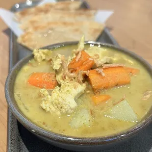 Close up of the yellow curry in roti canai