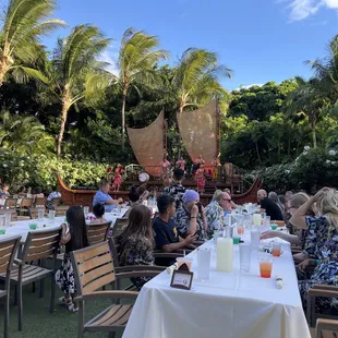 a group of people sitting at a table outside