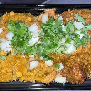 Chicken curry w lentils over veggie rice. Topped with cucumber and cilantro.