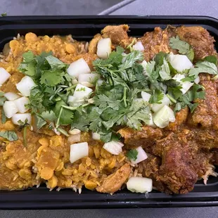 Chicken curry w lentils over veggie rice. Topped with cucumber and cilantro.