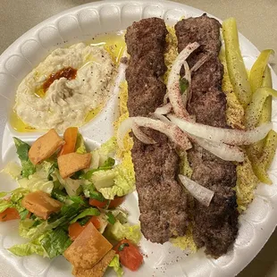 Kabab meal with side of salad and hummus
