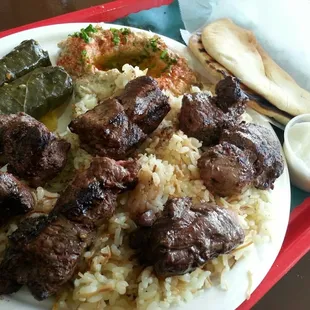Beef kabab plate, w/ grape leaves, baba ghanouj, rice, garlic sauce &amp; pita bread