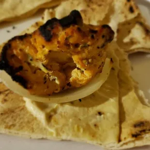 Spread the hummus on the flat bread and top with onion and charred meat, so good