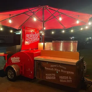 a food cart with a red umbrella