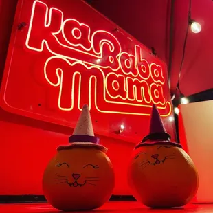 two ketchup bottles with faces painted on them