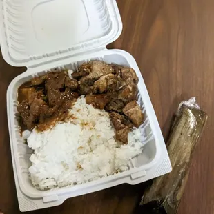 a plastic container with rice and meat