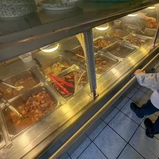 a child looking at food in a display case