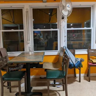 a table and chairs in front of a window