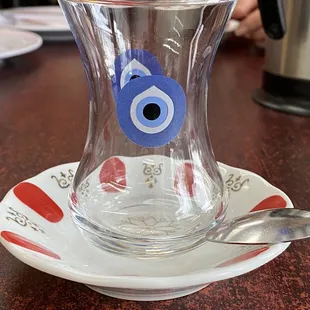 a cup with a spoon on a saucer