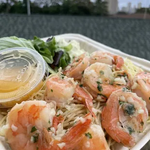 a plate of shrimp and noodles