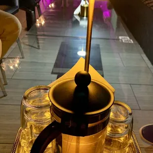 a tray with a teapot and glasses on it