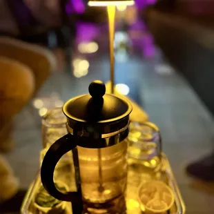 a teapot with a glass of tea