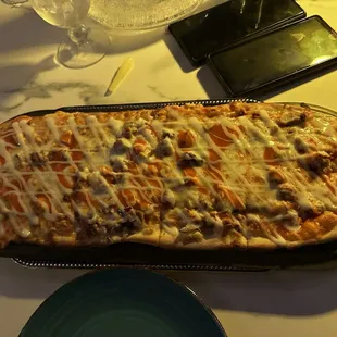 a pizza with cheese and olives