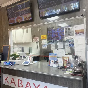 Ordering counter. Menu shown on flatscreens.