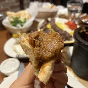 a hand holding a piece of food