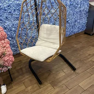 a hanging chair and a vase of flowers