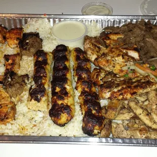 Shish Combo for 4. 2 chicken kabobs, 2 beef kabobs, 3 shish kafta, 3 chicken kafta, 2 chicken breasts, beef and chicken shawarma with rice.