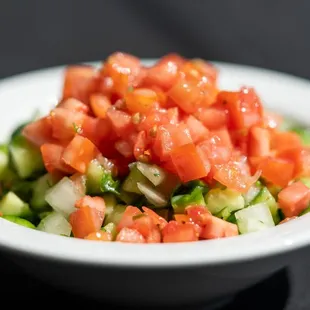 a bowl of chopped tomatoes and cucumbers