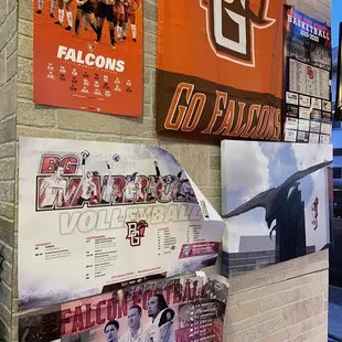 a brick wall with posters on it