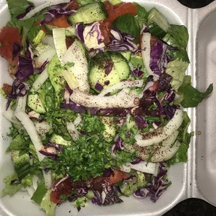 a salad in a styrofoam container