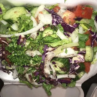 a salad in a styrofoam container