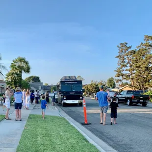 a group of people waiting to board a bus