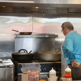 a man preparing food in a kitchen
