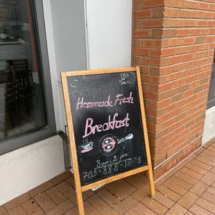 a blackboard sign outside of a restaurant