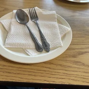 Food is served on plastic plates and water served in styrofoam cups