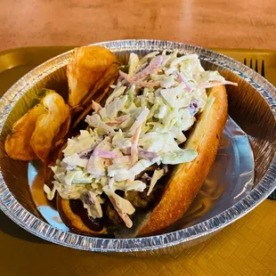 Pork BBQ with a toasted roll with fresh Cole slaw and home made chips!  Best Ever Sandwich!