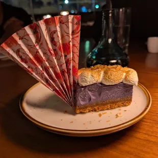 Ube Cheesecake. $14. Graham cracker crust, ube jam, topped with torched meringue, toasted coconut.