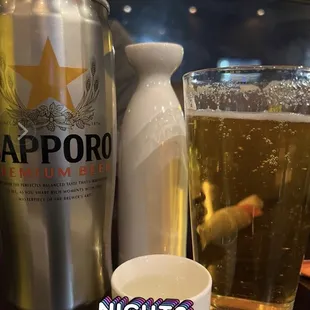 a glass of beer and a can