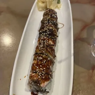 a sushi roll on a white plate