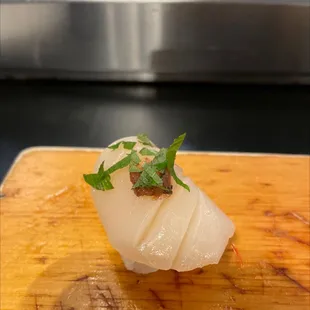 a piece of sushi on a cutting board