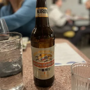 a glass of water and a bottle of beer
