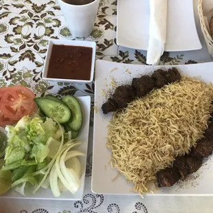 Fresh salad, lamb chunks, lots of rice, beans and afghani bread.