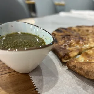 a bowl of soup and a piece of pizza