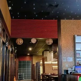 Entrance, black ceiling, and mini lights resemble stars.