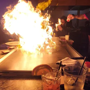 a chef cooking a flame